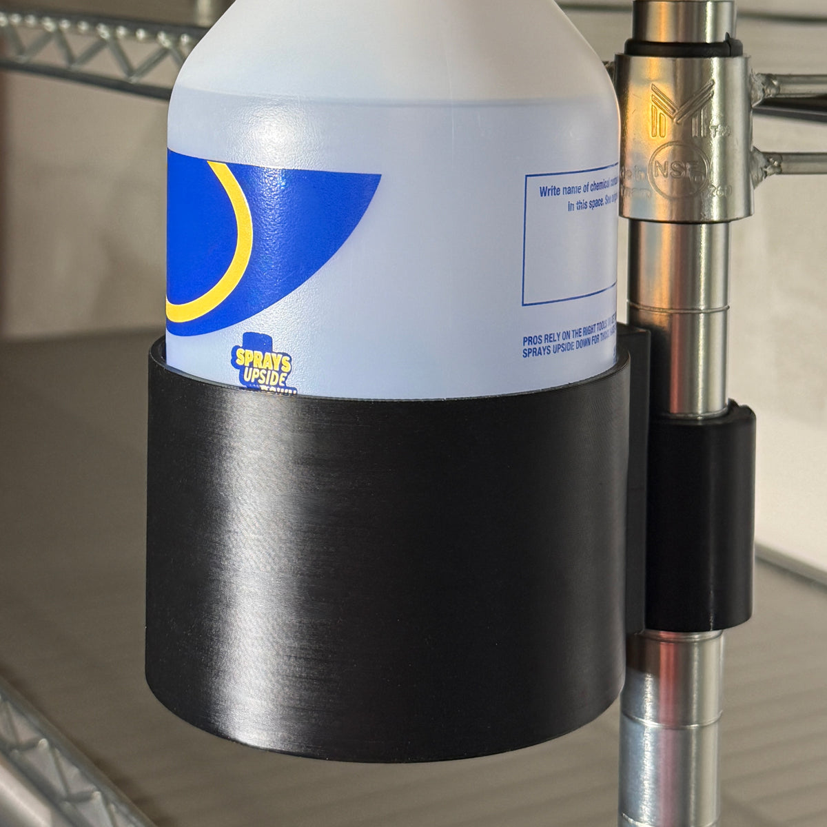 Black PETG 100 mm bottle holder with hinged adapter for a 1-inch diameter grooved shelving pole.