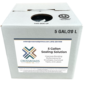 A white cardboard box of Crossroads Print Co. 5 Gallon Sealing Solution, with a large white label on the front and recycling symbols printed on the top surface.