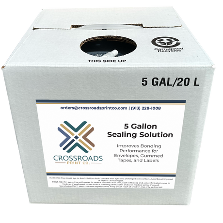 A white cardboard box of Crossroads Print Co. 5 Gallon Sealing Solution, with a large white label on the front and recycling symbols printed on the top surface.